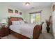 Cozy bedroom featuring a wooden bed frame, natural light, and neutral decor at 1628 E Aspen Ave, Buckeye, AZ 85326