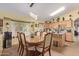Dining area featuring an elegant wood table with upholstered chairs and modern pendant lighting at 1628 E Aspen Ave, Buckeye, AZ 85326