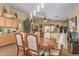 Open concept dining area connected to the living room, featuring an elegant wooden table set at 1628 E Aspen Ave, Buckeye, AZ 85326