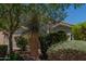 A home with a desert landscape, mature trees, and a well-manicured yard at 1628 E Aspen Ave, Buckeye, AZ 85326