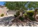 Charming home featuring a well-manicured lawn, mature trees, and a two-car garage at 1628 E Aspen Ave, Buckeye, AZ 85326