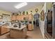 Well-lit kitchen with granite countertops, wooden cabinets, and an island with room for seating at 1628 E Aspen Ave, Buckeye, AZ 85326