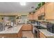 Well-lit kitchen with granite countertops, modern appliances, and ample cabinet space at 1628 E Aspen Ave, Buckeye, AZ 85326