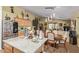 Open kitchen and dining area with granite countertops, wood cabinets, and decorative lighting at 1628 E Aspen Ave, Buckeye, AZ 85326