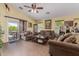 Spacious living room featuring comfortable sofas and a glass door leading to an outdoor area at 1628 E Aspen Ave, Buckeye, AZ 85326