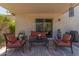 Covered patio with outdoor furniture, a ceiling fan, and sliding glass doors at 1628 E Aspen Ave, Buckeye, AZ 85326