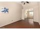 Bedroom with hardwood floors, natural lighting, and mirrored closet at 16288 W Hadley St, Goodyear, AZ 85338