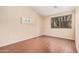 Empty bedroom showcasing tile floors and a bright window at 16288 W Hadley St, Goodyear, AZ 85338