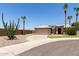 Charming single-story home with a tile roof, desert landscaping, and a circular driveway at 16288 W Hadley St, Goodyear, AZ 85338
