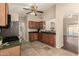Functional kitchen with stainless steel appliances, tile flooring, and a view to the backyard at 16288 W Hadley St, Goodyear, AZ 85338