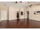 Large living room with tile floors, ceiling fans, and arched entryways at 16288 W Hadley St, Goodyear, AZ 85338
