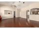 Spacious living room with decorative archways, ceiling fans, and tile flooring at 16288 W Hadley St, Goodyear, AZ 85338