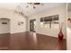 Open-concept living room with tile floors, ceiling fans, and large windows at 16288 W Hadley St, Goodyear, AZ 85338