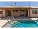 A shot from inside the pool toward the back patio at 16288 W Hadley St, Goodyear, AZ 85338