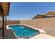 Beautiful blue swimming pool with a small waterfall feature at 16288 W Hadley St, Goodyear, AZ 85338