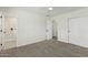 Bedroom with neutral carpet, ceiling fan, en suite bath, and closet with sliding doors at 1712 N Old Colony --, Mesa, AZ 85201