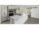 Modern kitchen with a large marble island, stainless steel appliances, and stylish backsplash at 1712 N Old Colony --, Mesa, AZ 85201