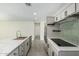 Bright kitchen featuring a marble-top island, gray cabinetry, and stainless steel appliances at 1712 N Old Colony --, Mesa, AZ 85201