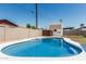 Clean backyard pool features a white concrete trim and brick wall surround at 1712 N Old Colony --, Mesa, AZ 85201