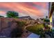 Inviting backyard with lush artificial turf, decorative landscaping, and privacy wall at 17812 W Primrose W Ln, Surprise, AZ 85374