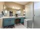 Well-lit primary bathroom featuring dual vanities, tiled floor, and walk-in shower at 17812 W Primrose W Ln, Surprise, AZ 85374