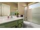 Well-maintained bathroom with a vanity, framed mirror, and a shower-tub combination with sliding glass doors at 17812 W Primrose W Ln, Surprise, AZ 85374