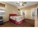 Cozy bedroom featuring a ceiling fan and adjoining bathroom at 17812 W Primrose W Ln, Surprise, AZ 85374