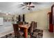 Well-lit dining room featuring a wooden table, patterned chairs, and a decorative ceiling fan above the dining set at 17812 W Primrose W Ln, Surprise, AZ 85374