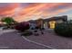 Inviting home with desert landscaping, arched entry, and a warm ambiance at sunset at 17812 W Primrose W Ln, Surprise, AZ 85374