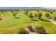 Scenic golf course view showcasing lush green fairways and mature trees against a backdrop of distant mountains at 17812 W Primrose W Ln, Surprise, AZ 85374
