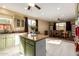 Open kitchen with center island, granite countertops, and breakfast nook at 17812 W Primrose W Ln, Surprise, AZ 85374