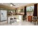 Bright kitchen with granite countertops, tiled backsplash, stainless appliances, and kitchen island with bar stool seating at 17812 W Primrose W Ln, Surprise, AZ 85374