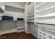 Spacious walk-in closet with ample shelving and rods for organization at 17812 W Primrose W Ln, Surprise, AZ 85374