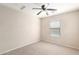 Bedroom with a ceiling fan, carpet flooring, and a window with bright natural light at 21182 E Stonecrest Dr, Queen Creek, AZ 85142