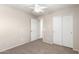 Bedroom featuring neutral carpet, ceiling fan, and direct access to the hallway closet at 21182 E Stonecrest Dr, Queen Creek, AZ 85142