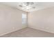 Bedroom with a ceiling fan, carpet flooring, and a window providing bright natural light at 21182 E Stonecrest Dr, Queen Creek, AZ 85142