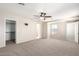 Large bedroom featuring walk-in closet, ceiling fan, and easy access to ensuite bathroom at 21182 E Stonecrest Dr, Queen Creek, AZ 85142