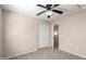 Bedroom with a ceiling fan, carpet flooring, and direct access to other rooms at 21182 E Stonecrest Dr, Queen Creek, AZ 85142