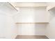 Walk-in closet featuring white walls and carpeted floor, with shelving and storage rods at 21182 E Stonecrest Dr, Queen Creek, AZ 85142