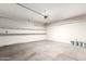 Spacious garage with ample shelving and smooth concrete flooring at 21182 E Stonecrest Dr, Queen Creek, AZ 85142