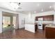 Eat in kitchen with white appliances, wood floors, granite counters, and sliding glass door to backyard at 21182 E Stonecrest Dr, Queen Creek, AZ 85142