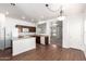 Bright kitchen with white island, wood floors, neutral paint, and open access to living room at 21182 E Stonecrest Dr, Queen Creek, AZ 85142
