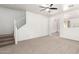 Spacious living room showcasing neutral carpet, white walls, and staircase at 21182 E Stonecrest Dr, Queen Creek, AZ 85142