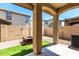 Covered patio offering a cozy outdoor space with gravel, artificial turf, and fire pit at 21182 E Stonecrest Dr, Queen Creek, AZ 85142