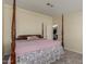 Spacious bedroom with decorative four-poster bed and ensuite bathroom access at 215 N Power Rd # 21, Mesa, AZ 85205
