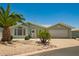 Charming single-story home with a two-car garage and desert landscaping at 215 N Power Rd # 21, Mesa, AZ 85205