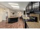 Galley kitchen with granite counters, wood floors, and skylight at 215 N Power Rd # 21, Mesa, AZ 85205