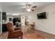 Open-concept living space featuring an adjacent kitchen and dining area with hardwood floors at 215 N Power Rd # 21, Mesa, AZ 85205