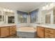 Ensuite bathroom features dual sinks, a large soaking tub and bright wallpaper at 215 N Power Rd # 21, Mesa, AZ 85205
