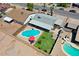 This aerial view showcases a backyard with a private pool, lush greenery, and an outdoor living space at 2207 W Bentrup St, Chandler, AZ 85224